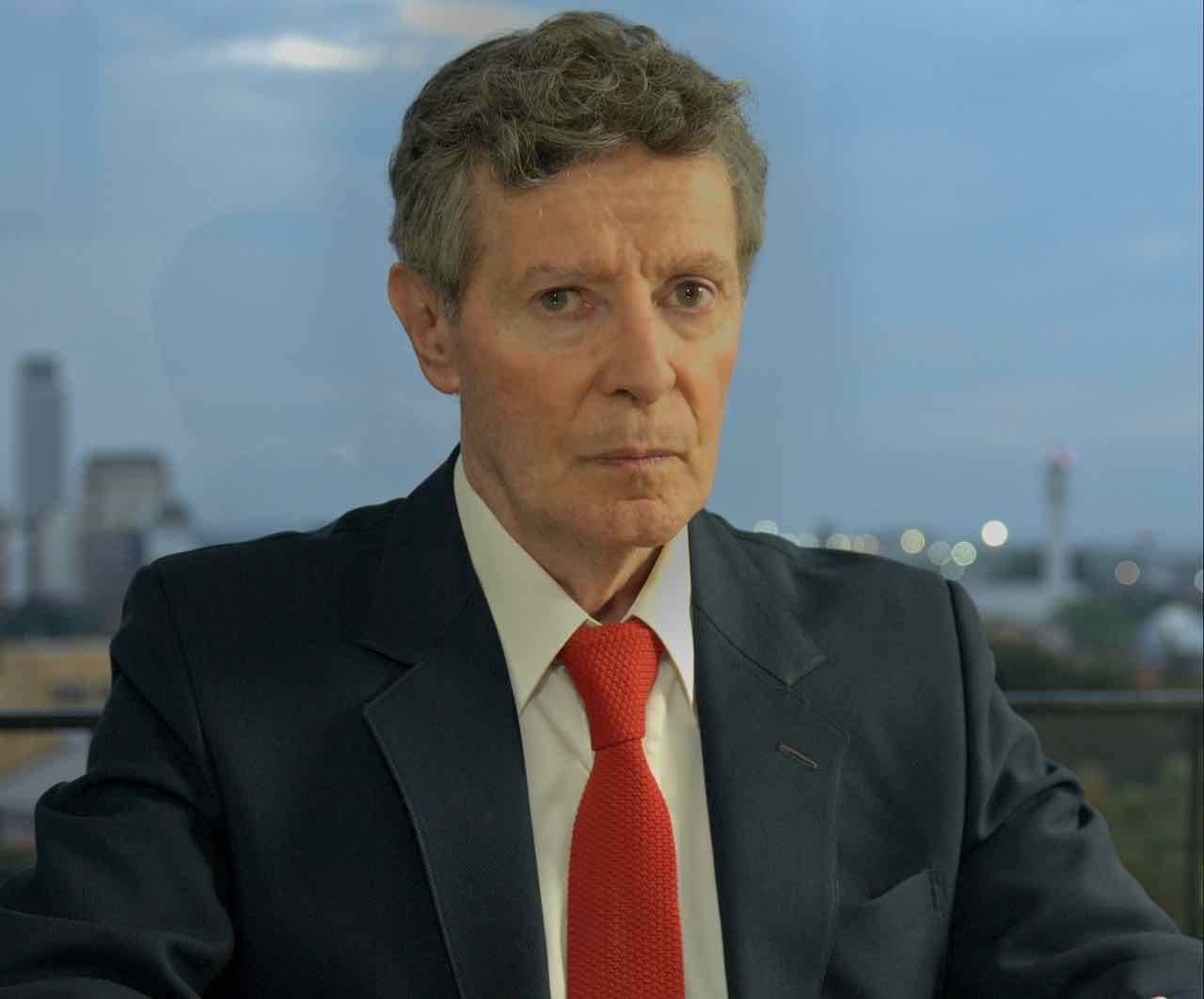 Carlos in an elegant suit in his office