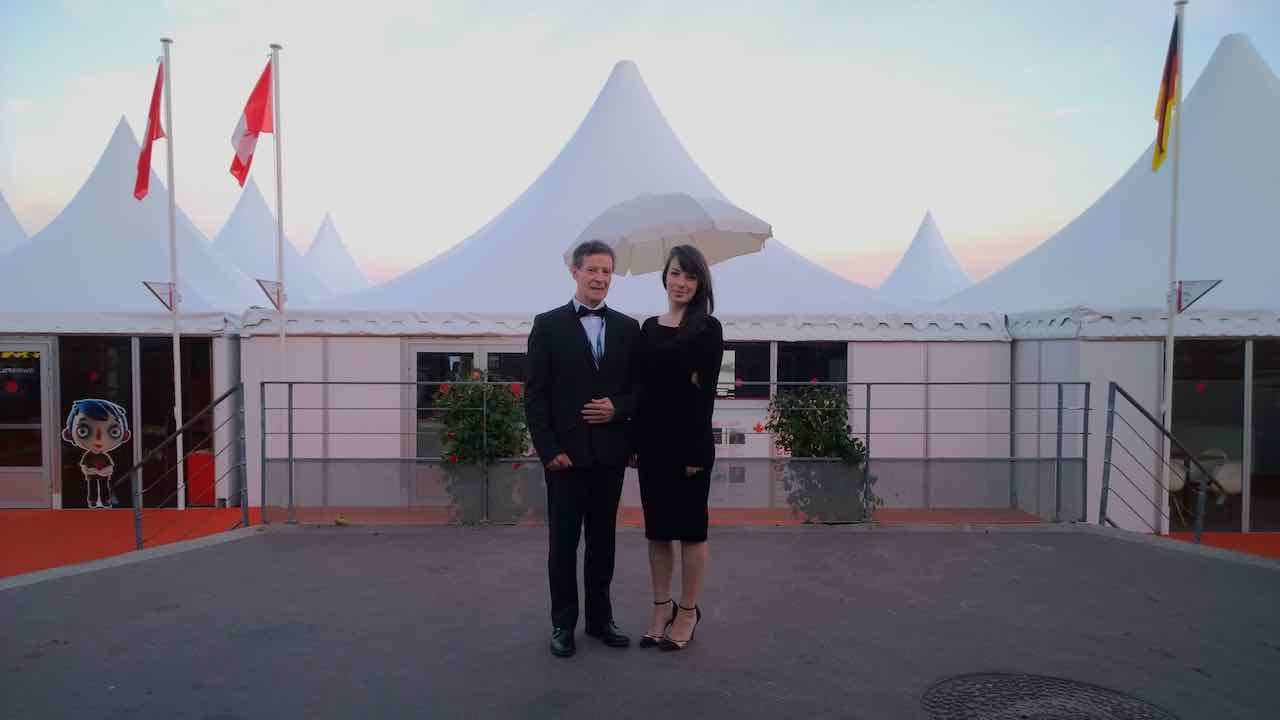 Carlos in a tuxedo at Cannes at sunset